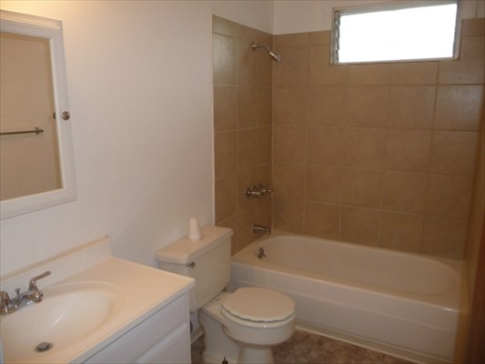 272 Kapiolani Street, Unit 204 Hilo, HI 96720 - Photo 3 of 10 a bathroom with a sink toilet and shower