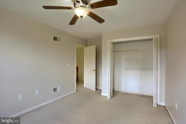 a view of a room with wooden floor and a sink