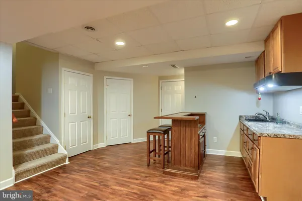 a kitchen with stainless steel appliances granite countertop a sink and a refrigerator