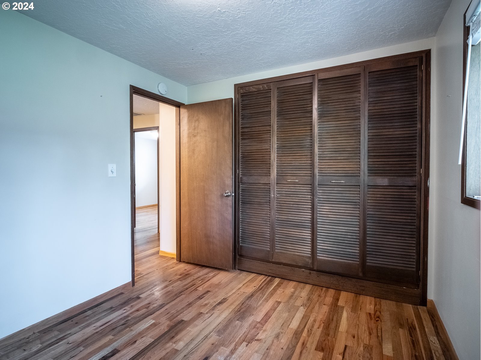 3238 Southeast 176th Place Portland, OR 97236 - Photo 13 of 31 an empty room with wooden floor and windows