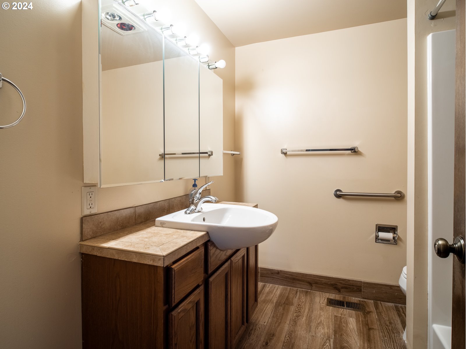 3238 Southeast 176th Place Portland, OR 97236 - Photo 15 of 31 a bathroom with a sink and a mirror