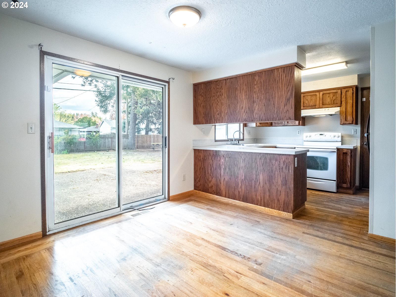 3238 Southeast 176th Place Portland, OR 97236 - Photo 6 of 31 a view of kitchen with granite countertop cabinets and wooden floor