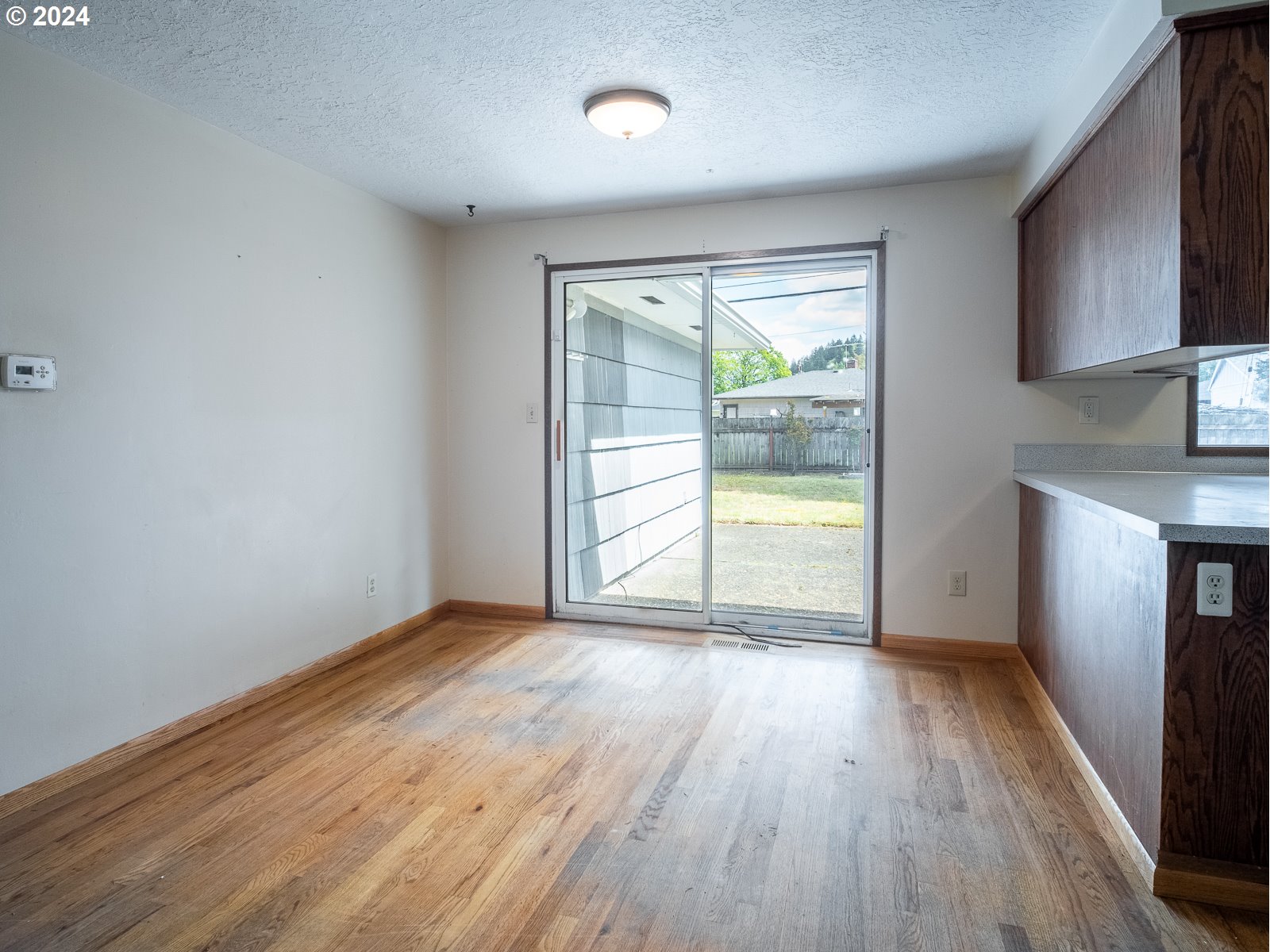 3238 Southeast 176th Place Portland, OR 97236 - Photo 7 of 31 wooden floor in an empty room with a window