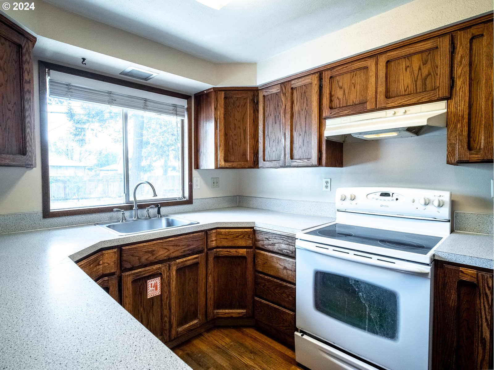 3238 Southeast 176th Place Portland, OR 97236 - Photo 8 of 31 a kitchen with a stove sink and cabinets