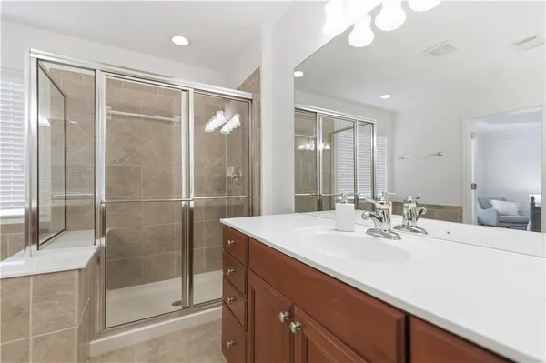 a large bed sitting in a bedroom next to a window