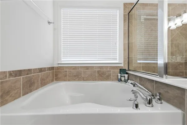 a bedroom with a bed tv and a window