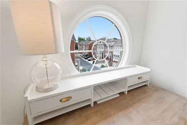 a view of a workspace with furniture and a window