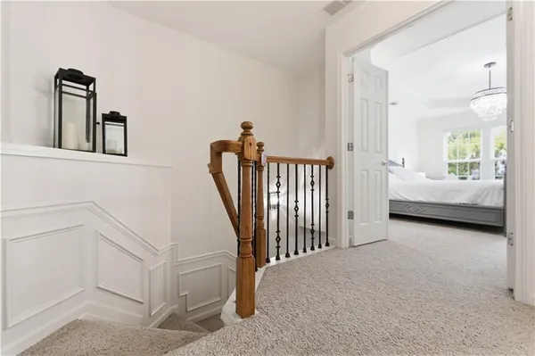 a view of a hallway with windows and stairs