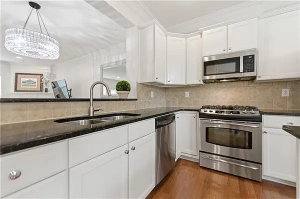 a view of a livingroom with furniture and hardwood floor