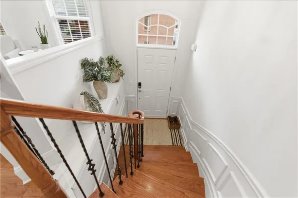 a dining room with furniture a chandelier and wooden floor