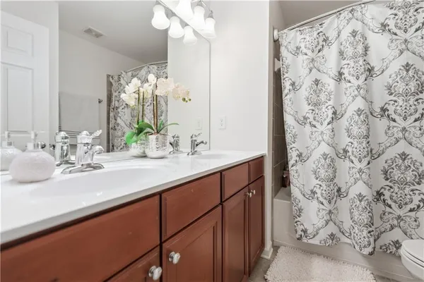 a spacious bedroom with a bed and a flat screen tv