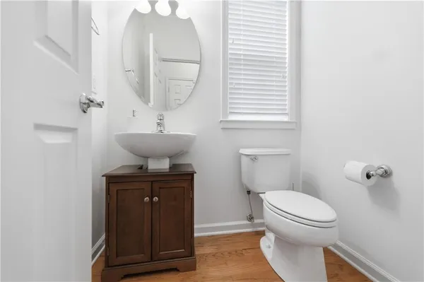 a view of a hallway with wooden floor and entryway