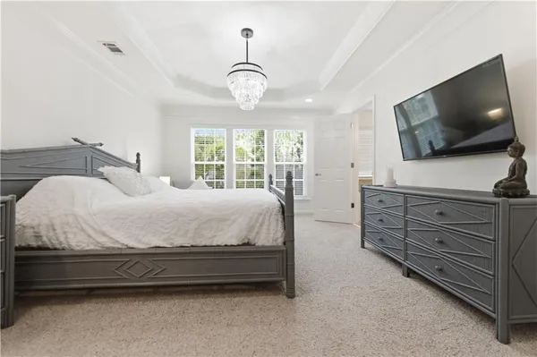 a bed room with a bed and a chandelier