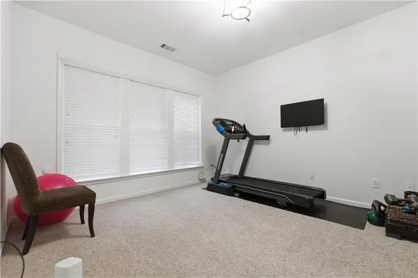 a view of a backyard with a large trees and wooden fence