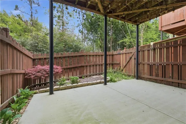 a view of a house with a yard and sitting area