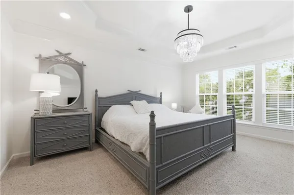 a spacious bathroom with a granite countertop sink and a mirror
