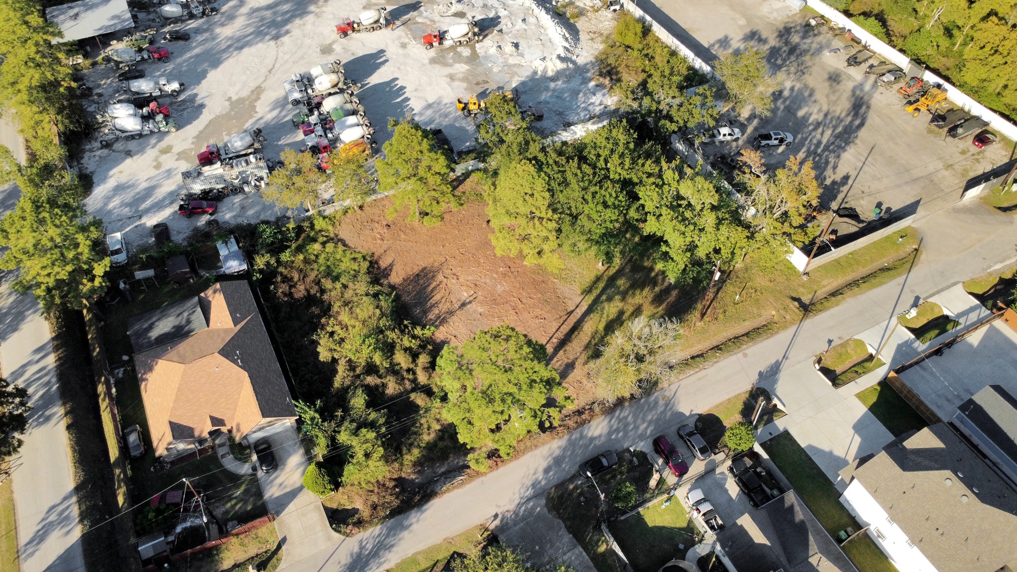 an aerial view of a residential houses with yard