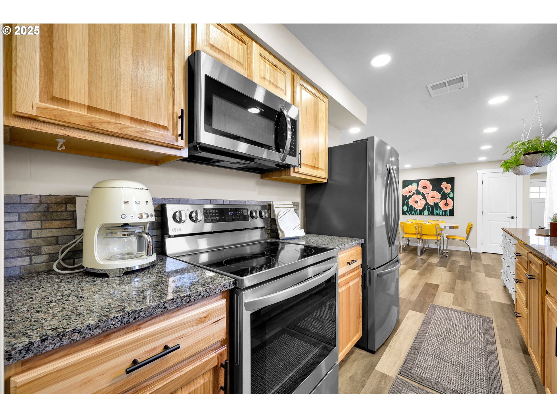 3045 Pheasant Boulevard Springfield, OR 97477 - Photo 14 of 43 a kitchen with stainless steel appliances granite countertop a stove a sink and a microwave