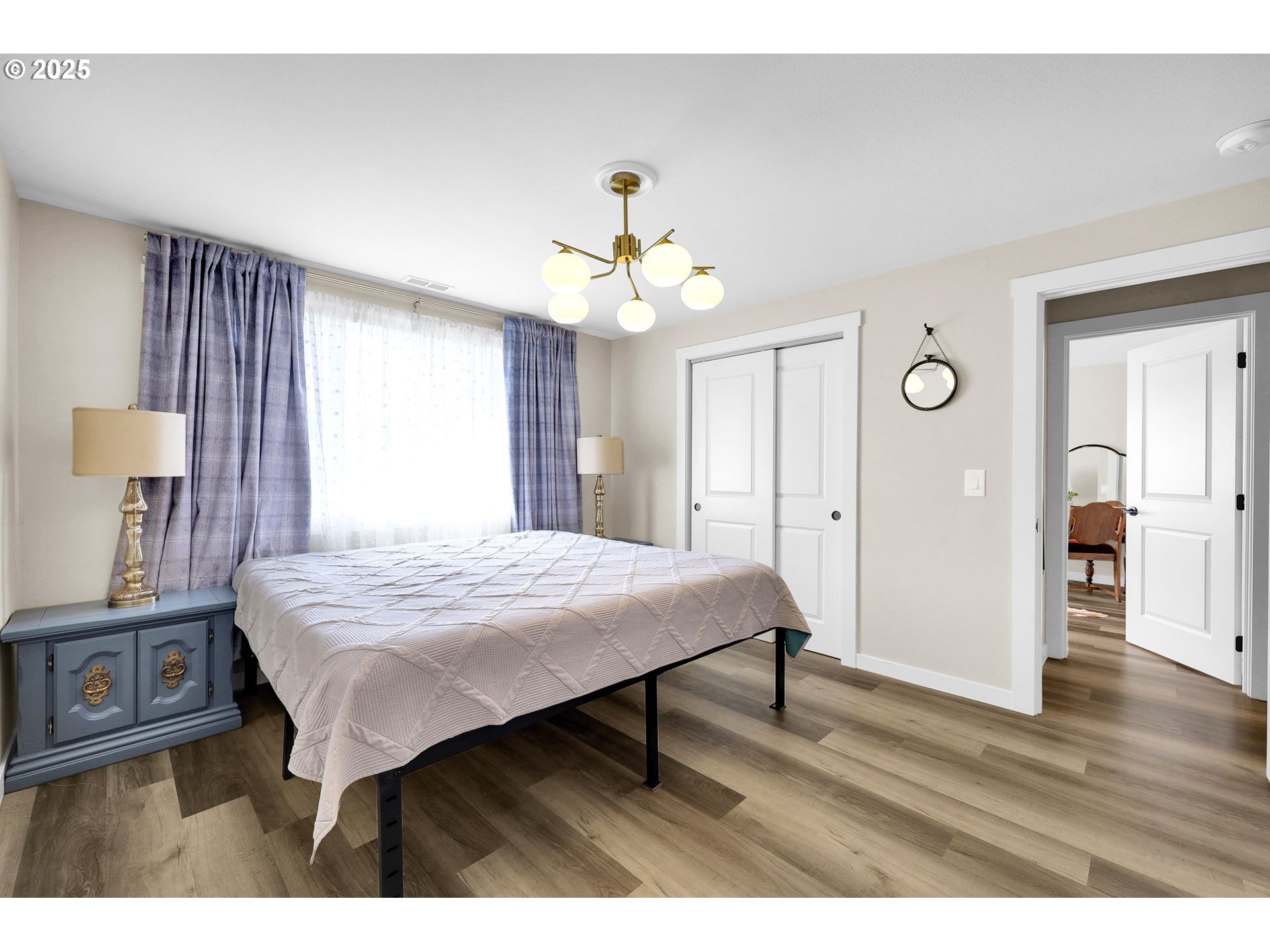 3045 Pheasant Boulevard Springfield, OR 97477 - Photo 22 of 43 a bedroom with a bed and a chandelier