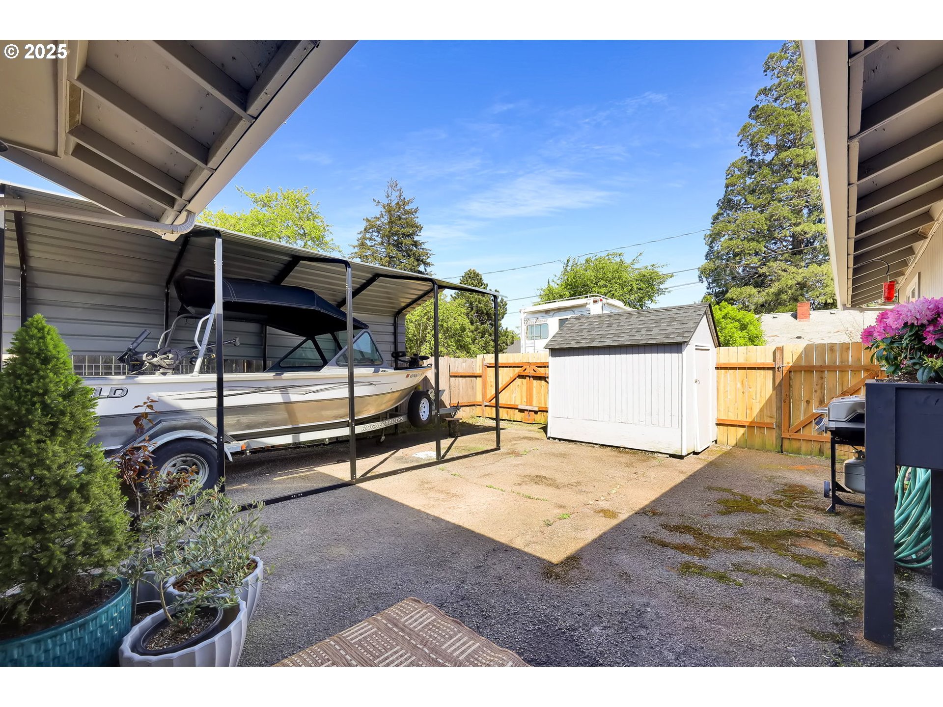 3045 Pheasant Boulevard Springfield, OR 97477 - Photo 40 of 43 a view of backyard with a table and chairs and potted plants