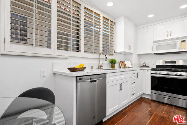 a kitchen with a sink cabinets and window
