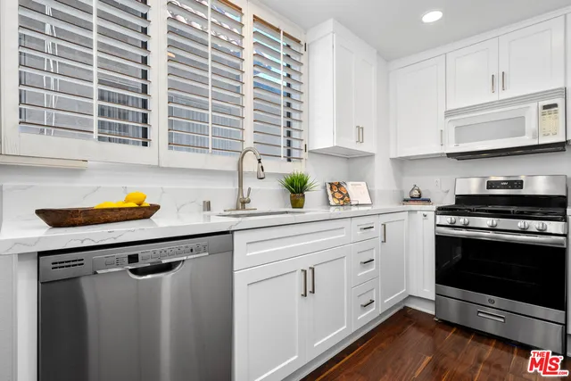 a kitchen with appliances cabinets and a sink