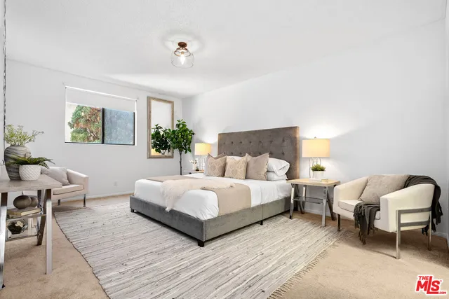 a bedroom with a bed and a couch