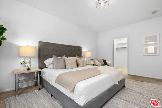 a bedroom with a bed and a lamp