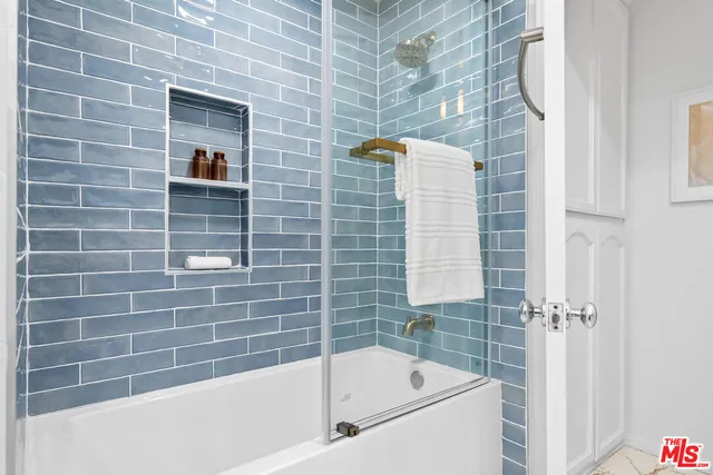 a bathroom with a bathtub and shower