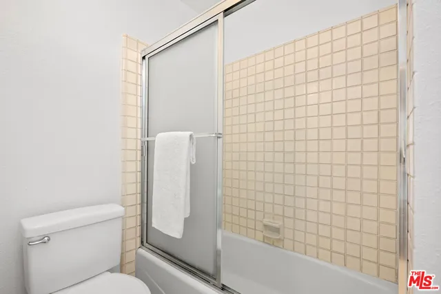 a bathroom with a toilet and shower