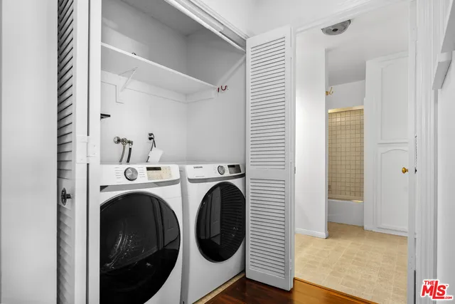 a view of a hallway with washer and dryer