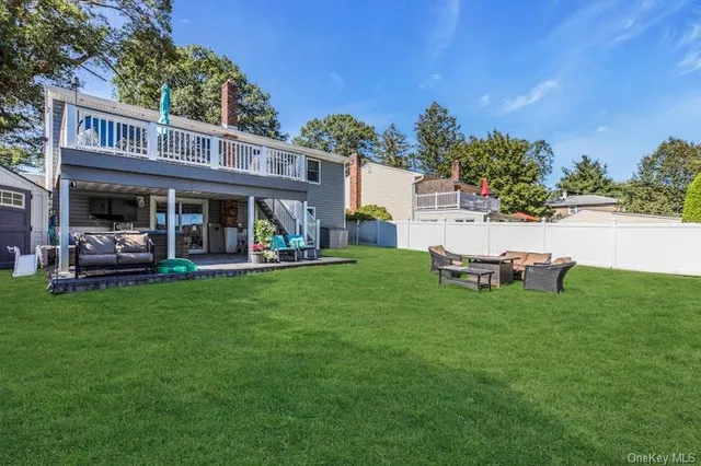 a view of a house with a backyard porch and sitting area