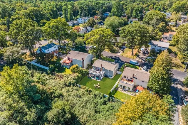 an aerial view of a house with a yard basket ball court and outdoor seating