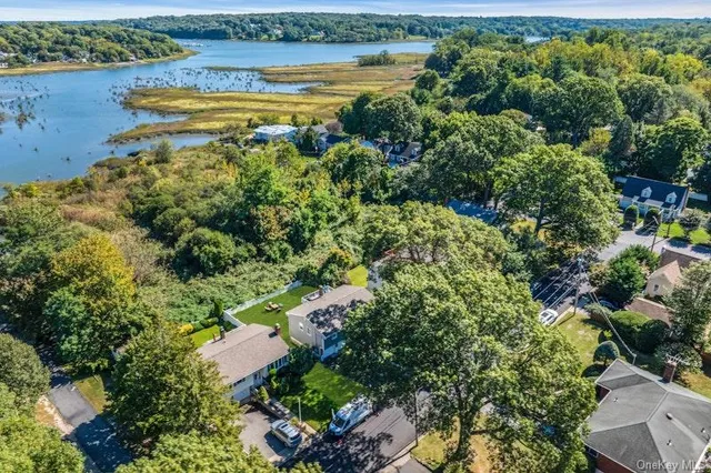 an aerial view of a houses with outdoor space and swimming pool