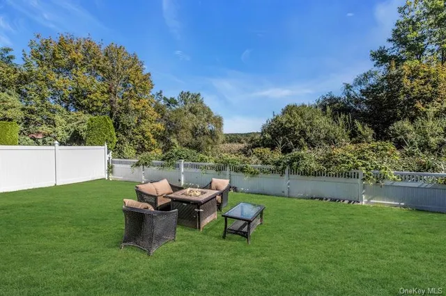 a backyard of a house with table and chairs