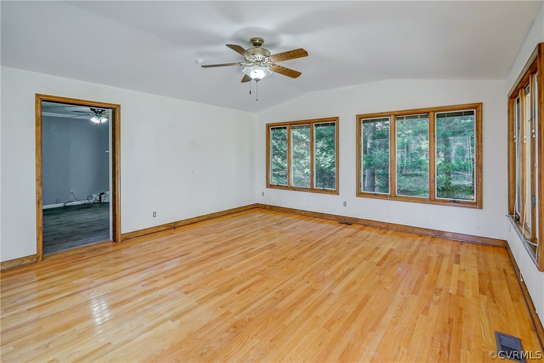 11411 Rochelle Road Chester, VA 23831 - Photo 22 of 50 a view of an empty room with a window and wooden floor