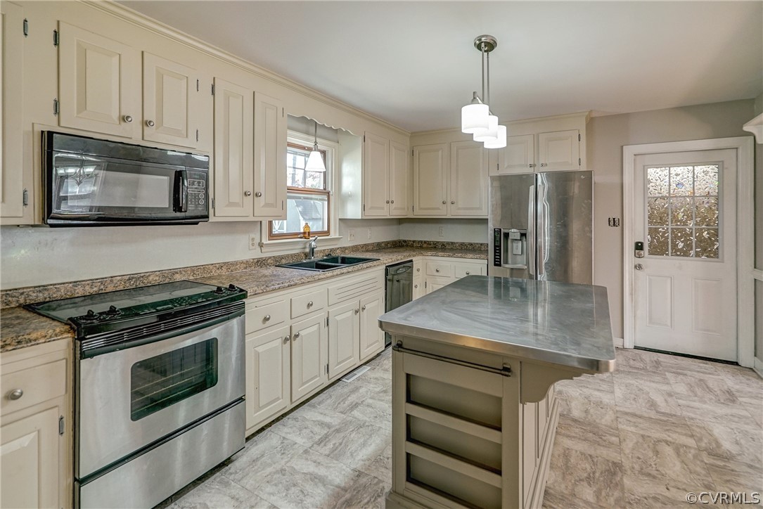 11411 Rochelle Road Chester, VA 23831 - Photo 27 of 50 a kitchen with stainless steel appliances granite countertop a stove a sink and a microwave