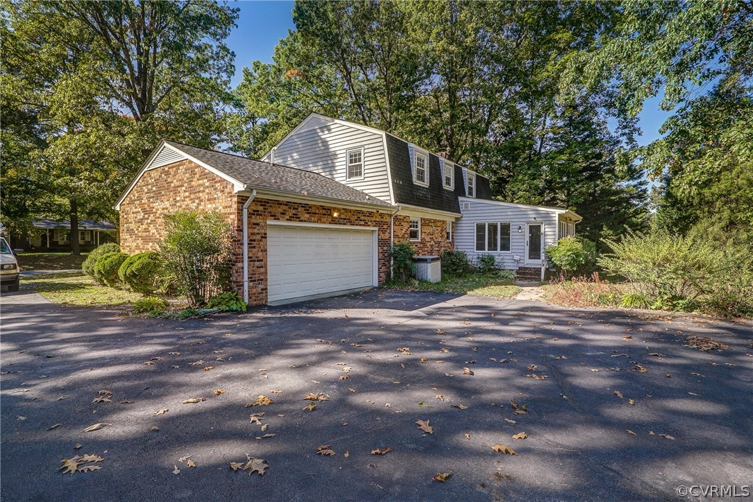 11411 Rochelle Road Chester, VA 23831 - Photo 40 of 50 a front view of a house with a yard and garage