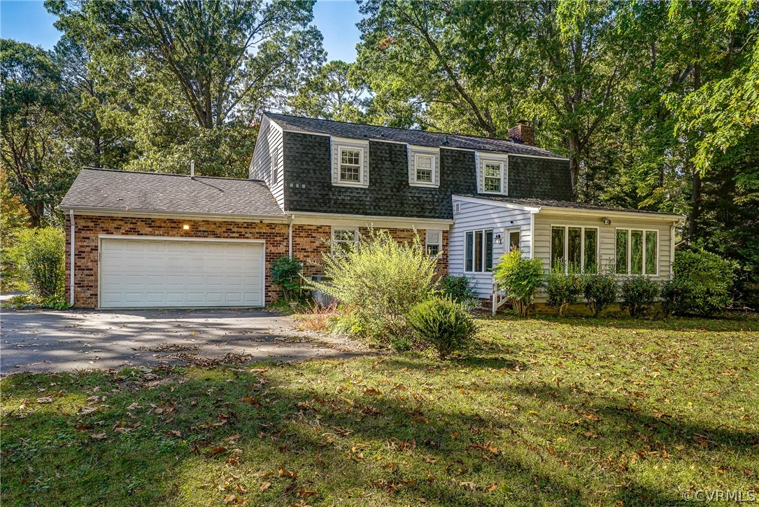 11411 Rochelle Road Chester, VA 23831 - Photo 43 of 50 a front view of a house with a garden and yard