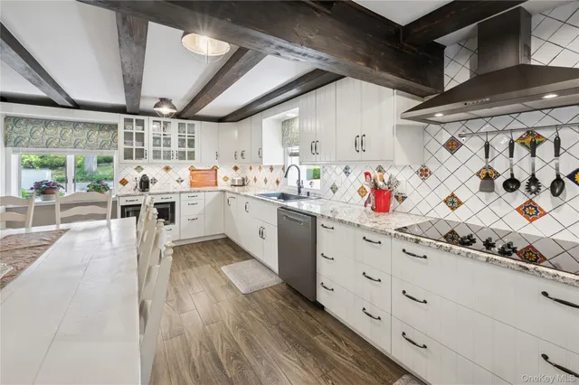 a kitchen with stainless steel appliances granite countertop a sink and cabinets