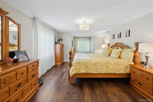 a bedroom with a bed and a dresser in it