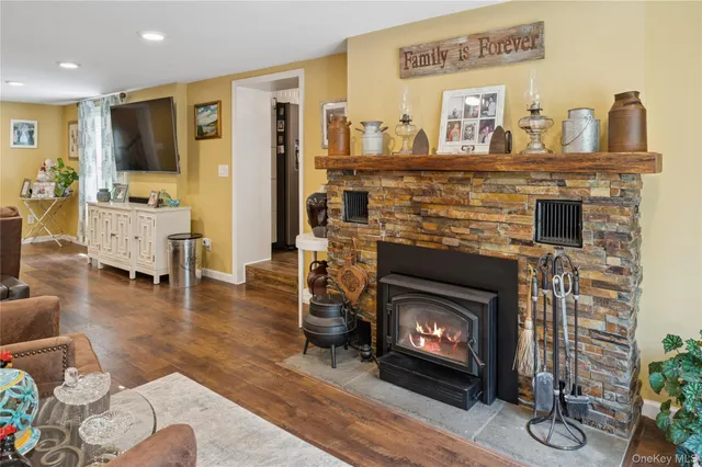a living room with furniture a fireplace and a flat screen tv
