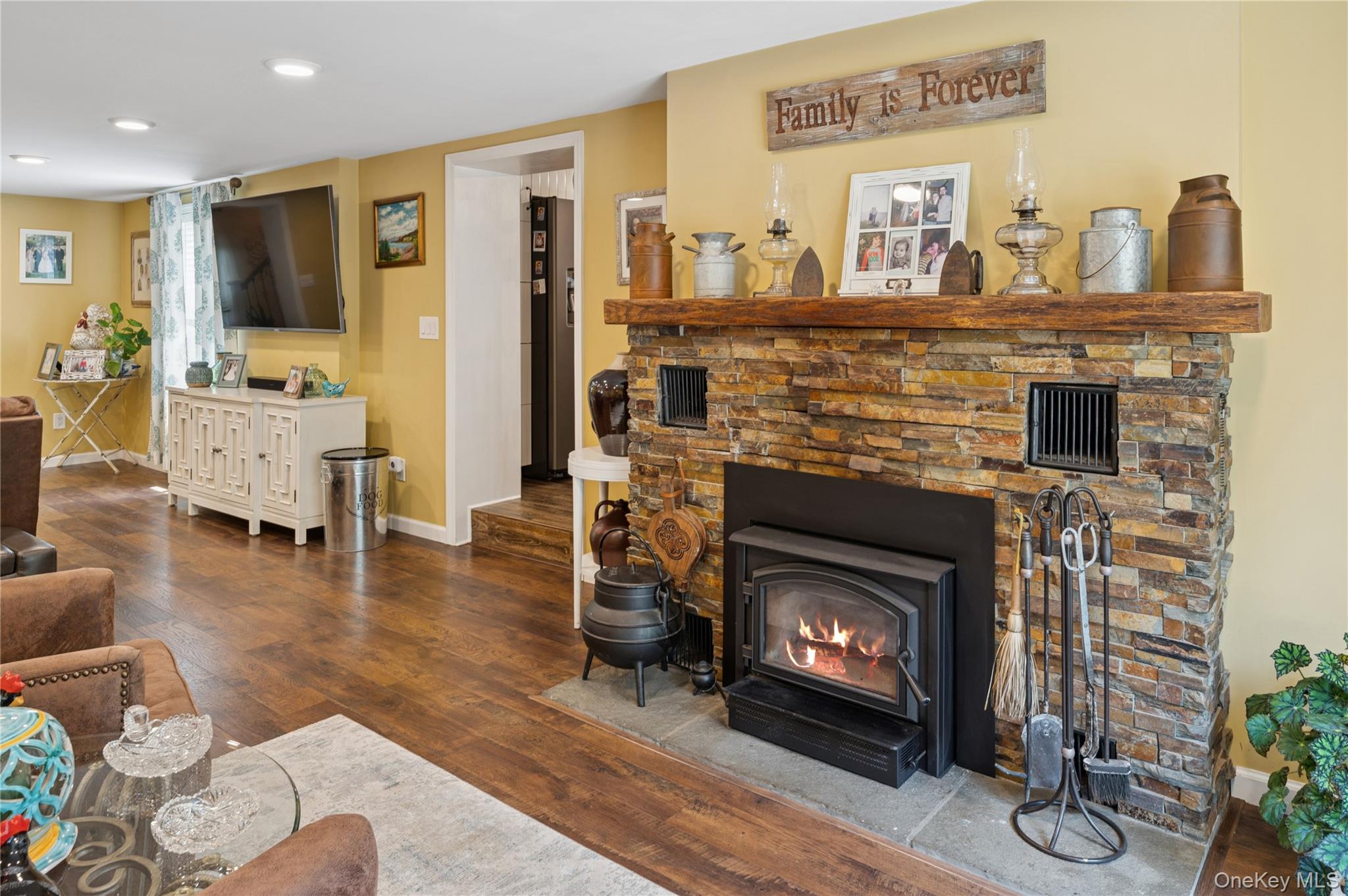 123 Pleasant Road Lake Peekskill, NY 10537 - Photo 17 of 50 a living room with furniture a fireplace and a flat screen tv