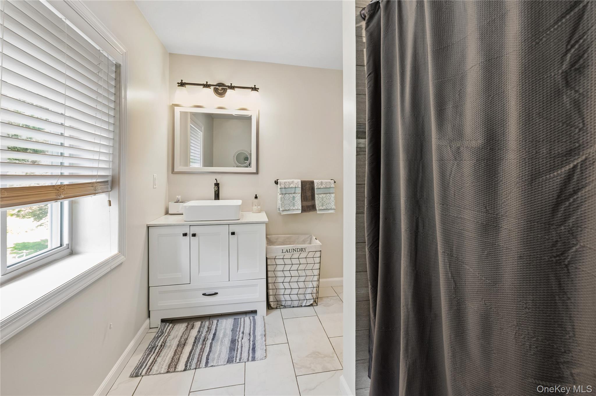 123 Pleasant Road Lake Peekskill, NY 10537 - Photo 22 of 50 a bathroom with a sink mirror and a bathtub