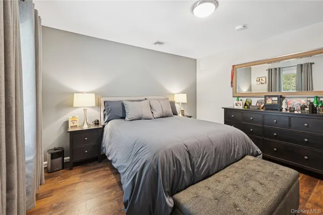 a bedroom with a bed and a dresser