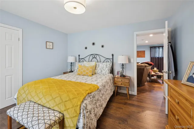 a bedroom with bed and wooden floor