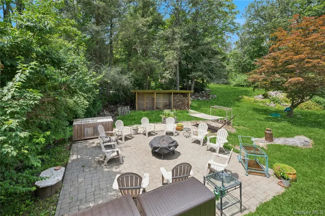 a view of a patio with table and chairs potted plants with large tree