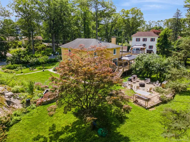 an aerial view of a house with a yard
