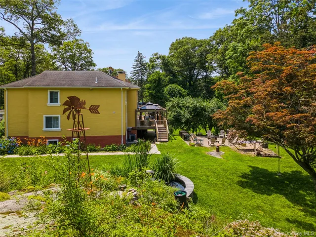 a view of backyard of house with green space
