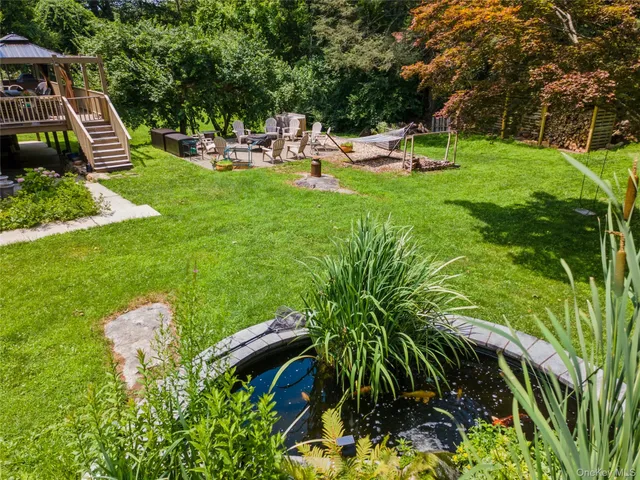 a view of a backyard with swimming pool